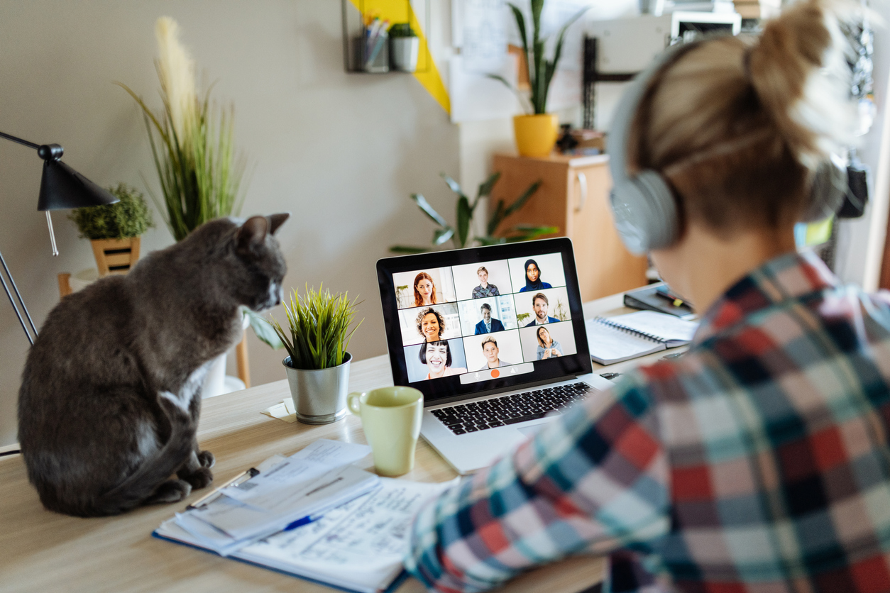 A woman speaking to her colleagues on a video call about the benefits of hiring remote workers