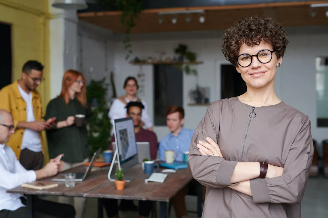 A business woman smiling after using an IT specialist recruitment agency to successfully hire great tech talent